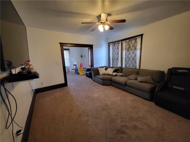 carpeted living room featuring ceiling fan