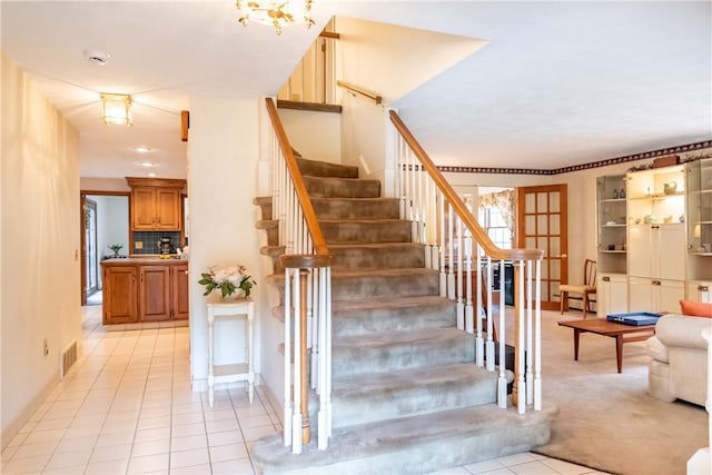 staircase with tile patterned floors