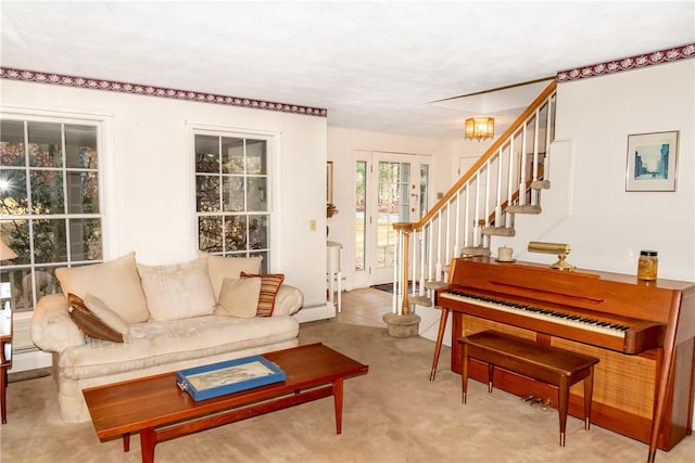 living room with a baseboard radiator and light colored carpet