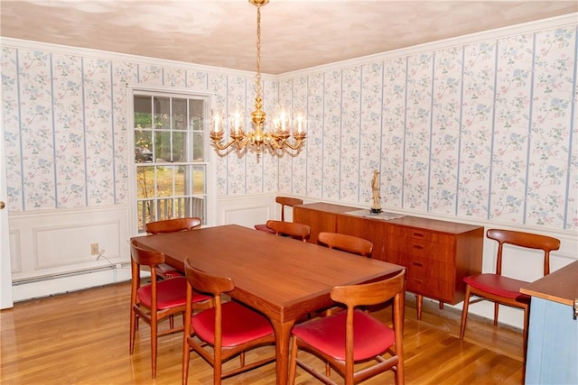 dining area featuring a notable chandelier, a baseboard radiator, ornamental molding, and light wood-type flooring