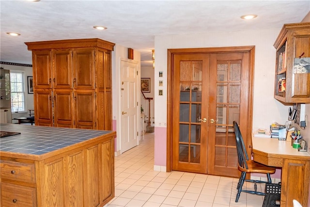 kitchen with light tile patterned flooring and tile counters