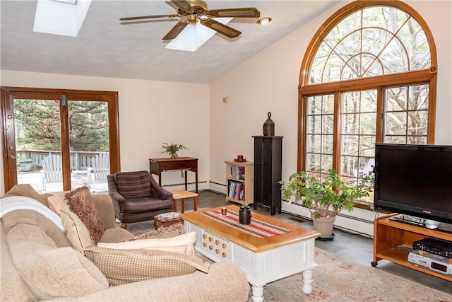 living room with baseboard heating, ceiling fan, and lofted ceiling with skylight