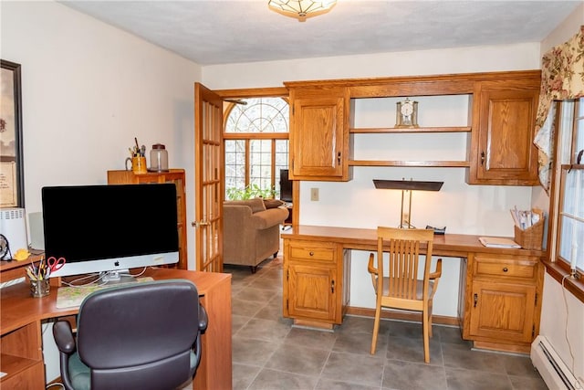 office featuring built in desk and a baseboard radiator