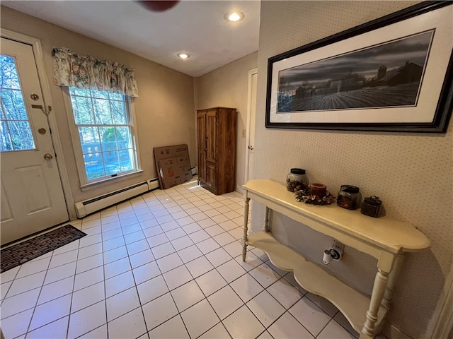 foyer entrance with a baseboard heating unit and light tile patterned floors