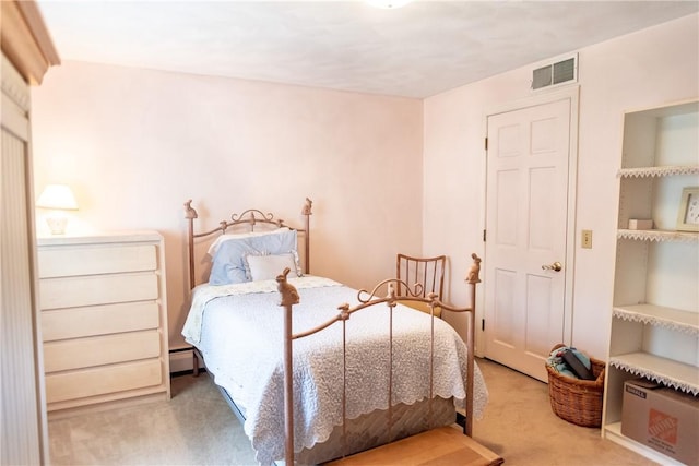 carpeted bedroom featuring a baseboard heating unit