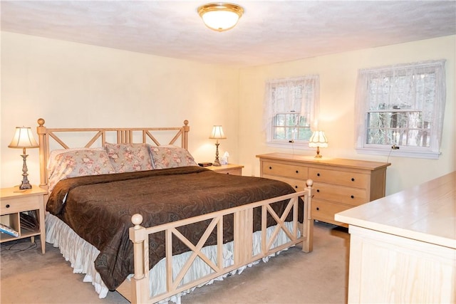 bedroom featuring light carpet