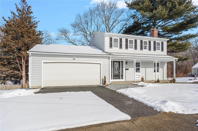 view of front of property with a garage and covered porch