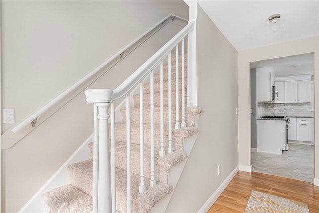 stairway with hardwood / wood-style flooring