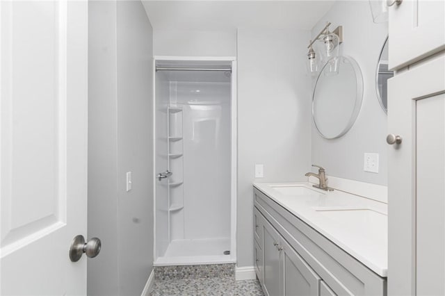 bathroom featuring a shower and vanity