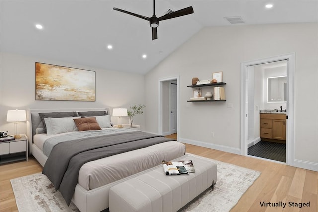 bedroom featuring lofted ceiling, sink, ceiling fan, connected bathroom, and light hardwood / wood-style floors