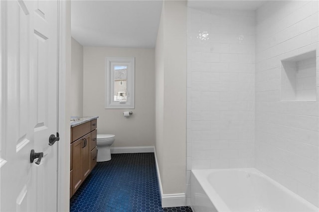 full bathroom with vanity, tiled shower / bath, and toilet