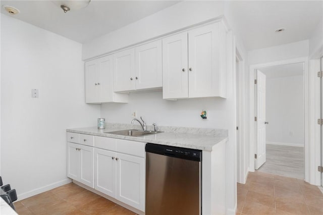 kitchen with white cabinetry, light tile patterned flooring, dishwasher, and sink