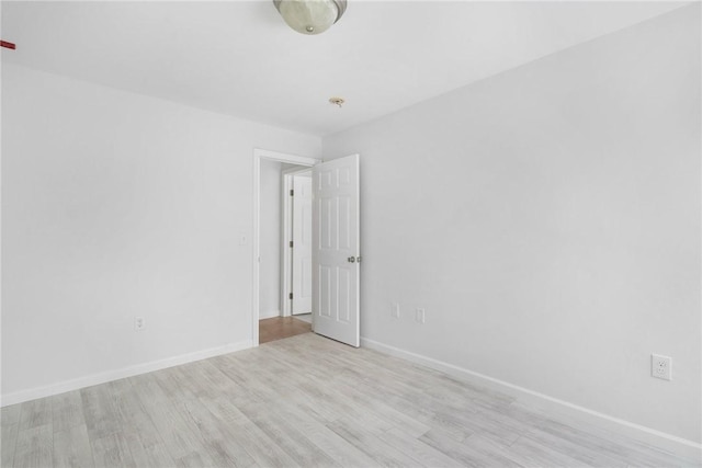 unfurnished room with light wood-type flooring