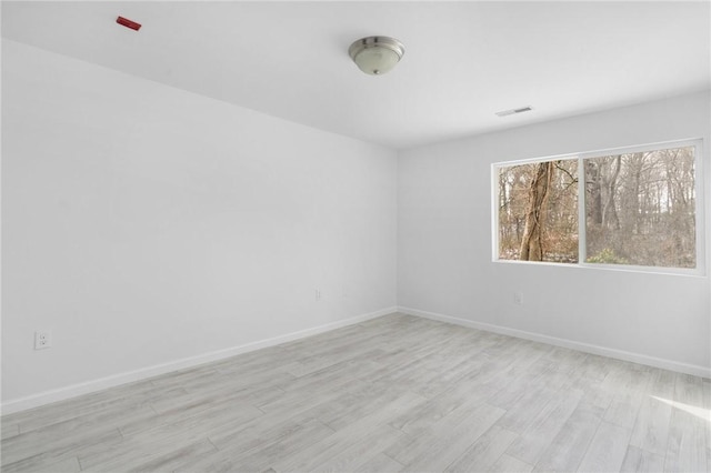 spare room featuring light hardwood / wood-style floors