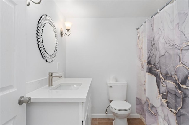 bathroom with vanity, tile patterned floors, and toilet