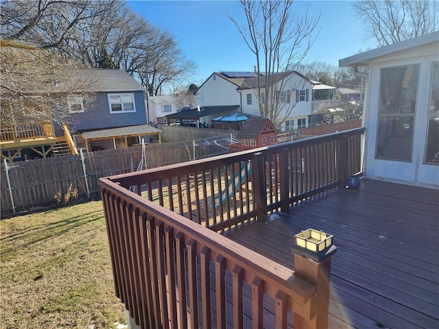 wooden terrace featuring a yard