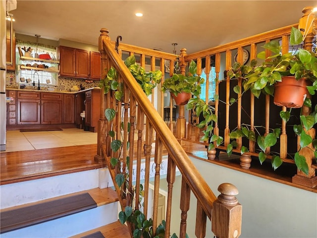 stairway featuring sink