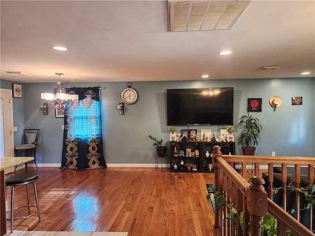 living room with hardwood / wood-style flooring and a chandelier