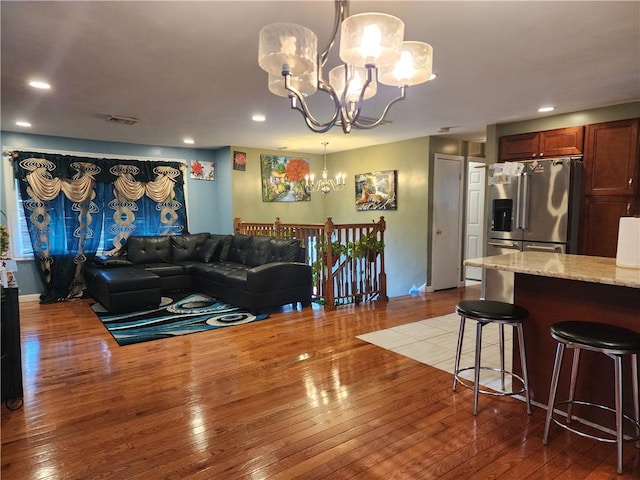 living room with hardwood / wood-style floors and a chandelier