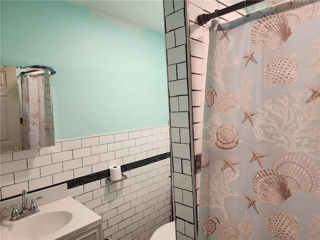 bathroom featuring tile walls, vanity, toilet, and a shower with shower curtain