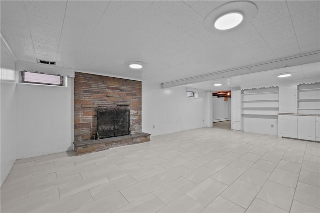 unfurnished living room featuring a stone fireplace