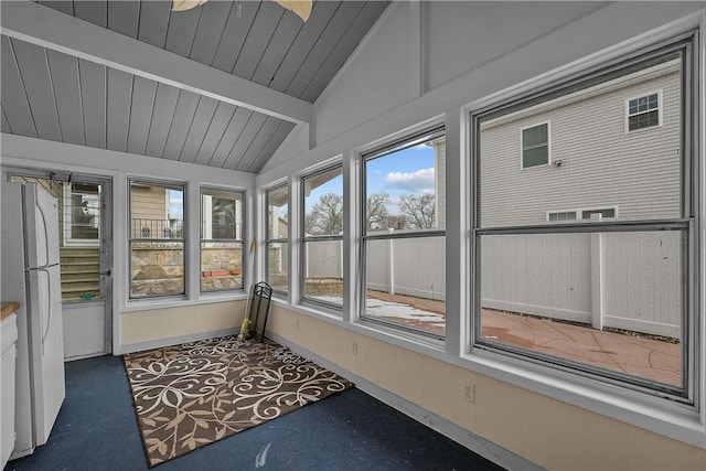 unfurnished sunroom with vaulted ceiling with beams and wood ceiling