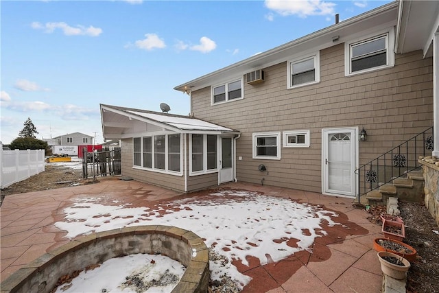 rear view of house featuring a patio and a sunroom