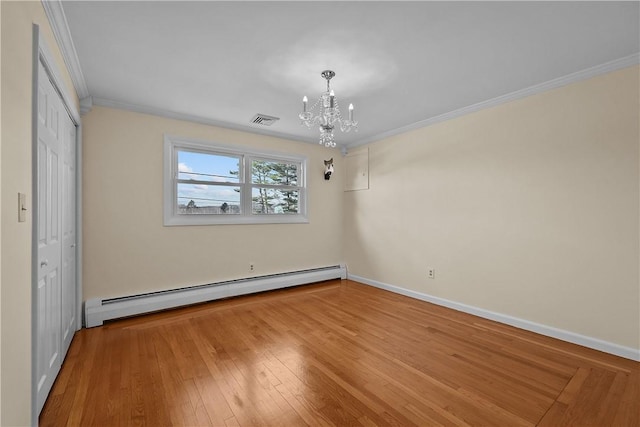 interior space featuring crown molding, baseboard heating, a closet, a notable chandelier, and hardwood / wood-style flooring