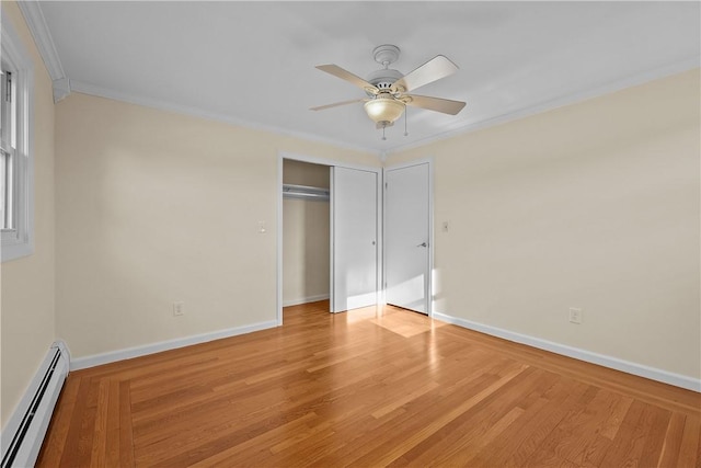 unfurnished bedroom with crown molding, a baseboard radiator, ceiling fan, and light wood-type flooring