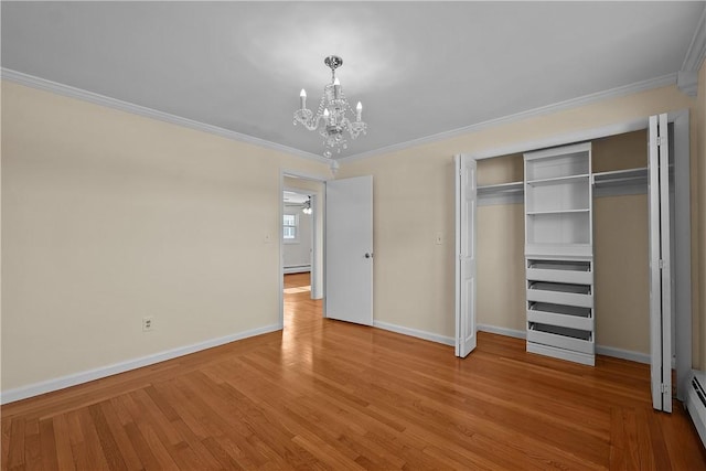 unfurnished bedroom with wood-type flooring, ornamental molding, a closet, a notable chandelier, and a baseboard heating unit