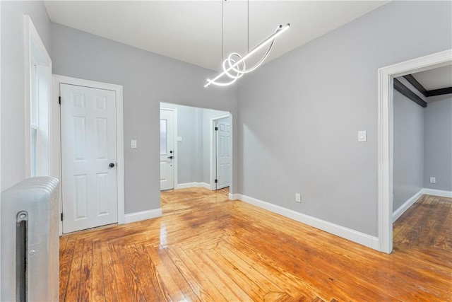 unfurnished dining area with parquet floors and an inviting chandelier