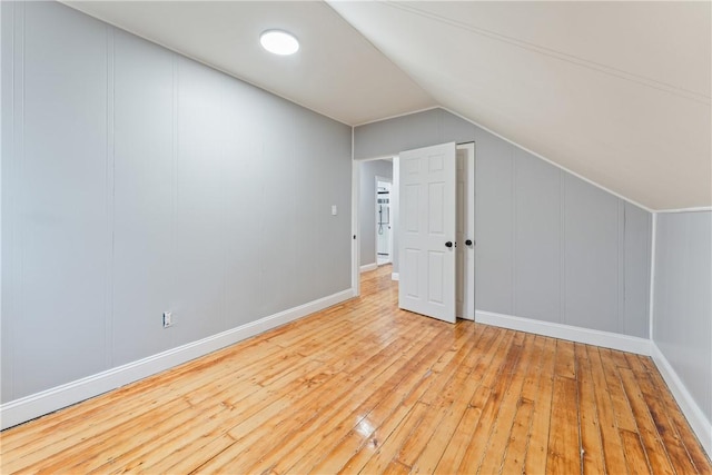 bonus room with vaulted ceiling and light hardwood / wood-style floors