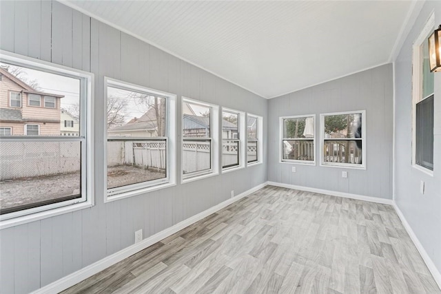 unfurnished sunroom with vaulted ceiling