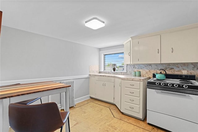45 Ayrault St Unit 11, Newport, RI 02840 - kitchen featuring sink, radiator, backsplash, white range oven, and white cabinets