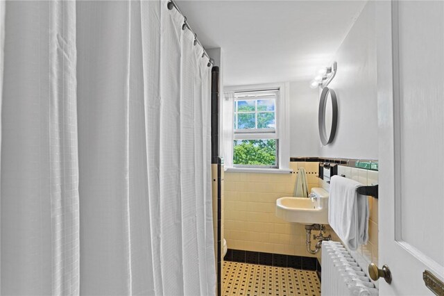 45 Ayrault St Unit 11, Newport, RI 02840 - bathroom featuring curtained shower, radiator, and tile walls