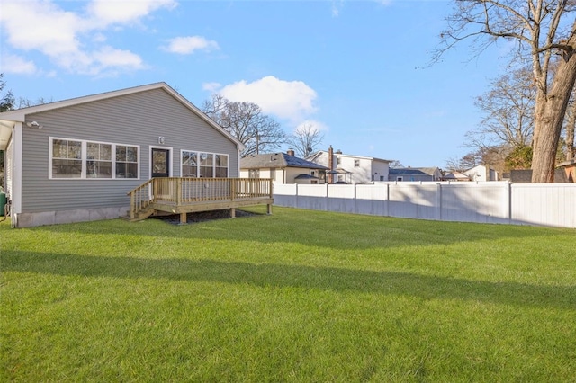 back of property featuring a wooden deck and a yard