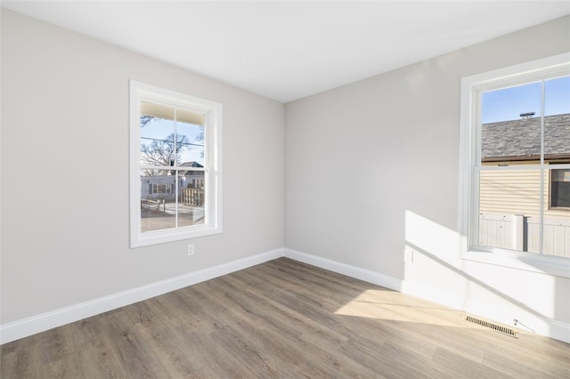 unfurnished room with hardwood / wood-style flooring