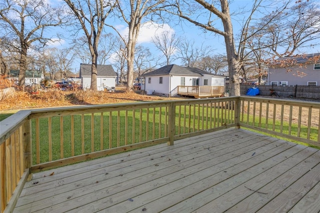 wooden deck featuring a lawn