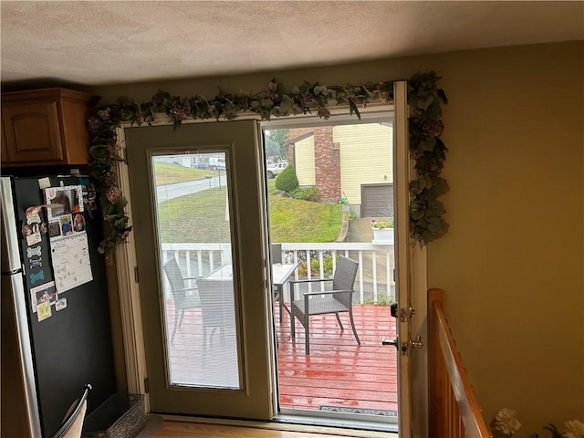 doorway featuring a textured ceiling