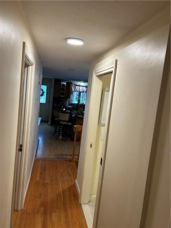 corridor with light wood-type flooring