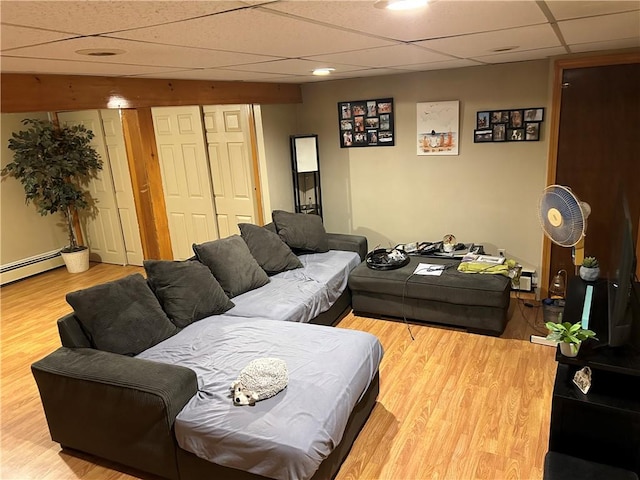 living room with wood-type flooring and a paneled ceiling