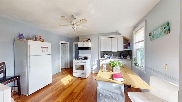 kitchen featuring white appliances, ceiling fan, white cabinets, decorative backsplash, and light wood-type flooring