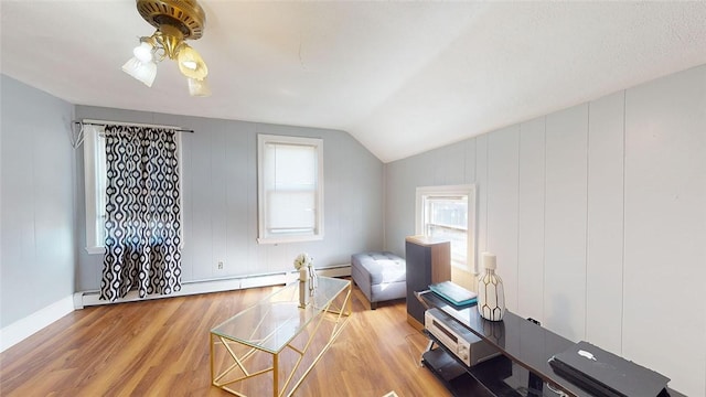 bonus room with hardwood / wood-style flooring, a baseboard radiator, vaulted ceiling, and ceiling fan