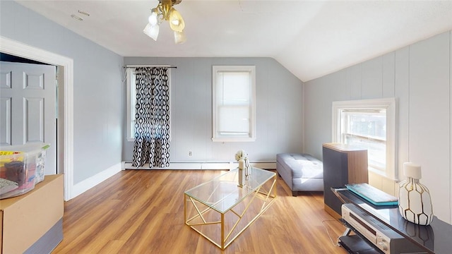 living area with lofted ceiling and light hardwood / wood-style flooring