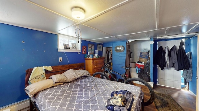 bedroom featuring a baseboard radiator and wood-type flooring