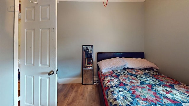 bedroom with wood-type flooring