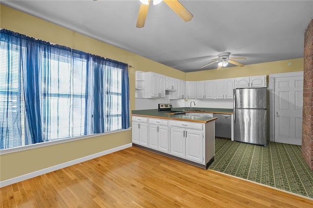 kitchen with sink, ceiling fan, stainless steel appliances, light hardwood / wood-style floors, and white cabinets