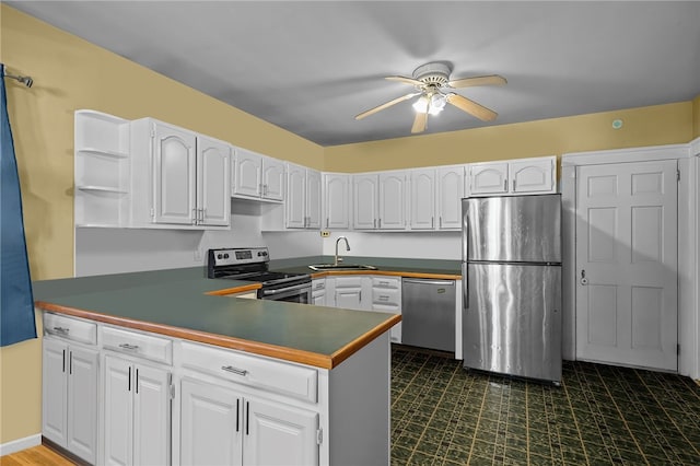 kitchen with white cabinetry, sink, kitchen peninsula, and appliances with stainless steel finishes