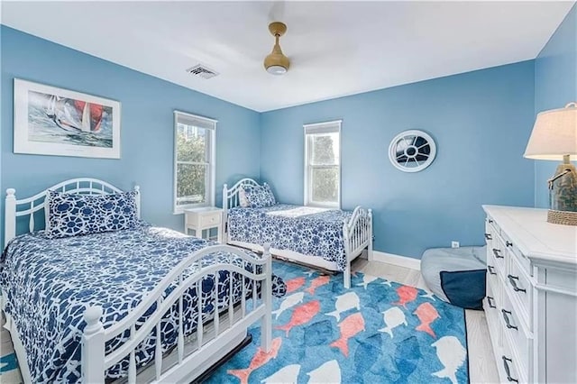 bedroom featuring multiple windows and light hardwood / wood-style floors