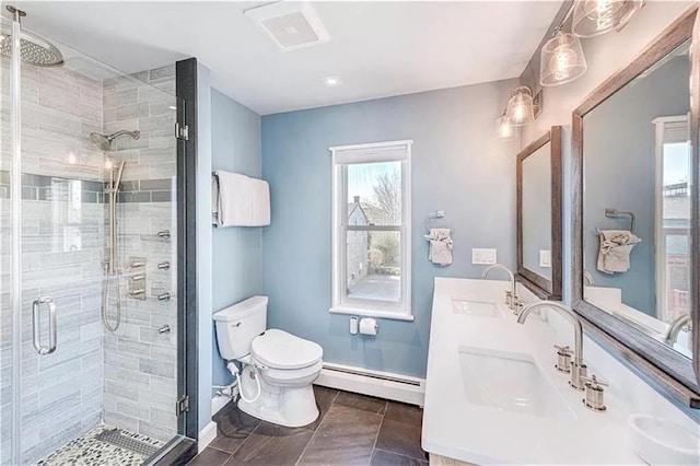 bathroom with tile patterned floors, toilet, a shower with shower door, baseboard heating, and vanity